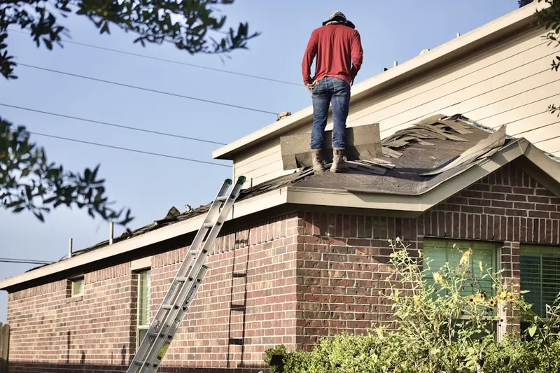 Professional roofer working on a residential roof in Rocky Point